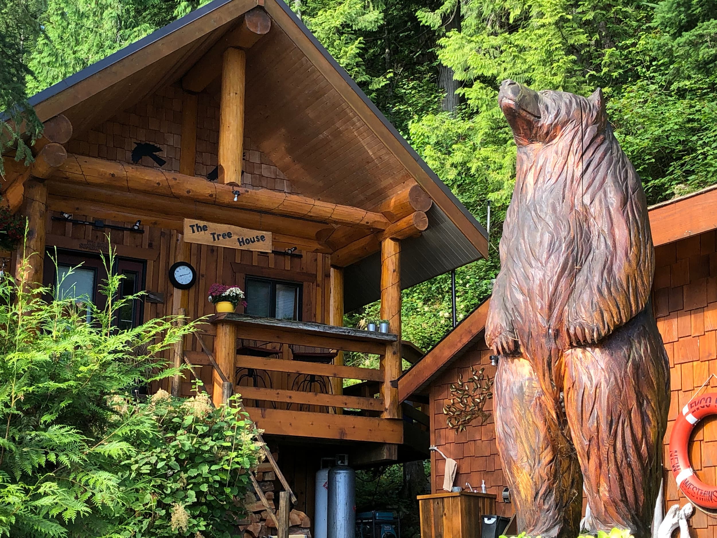 Wooden treehouse structure labeled 'The Tree House' surrounded by lush green forest
