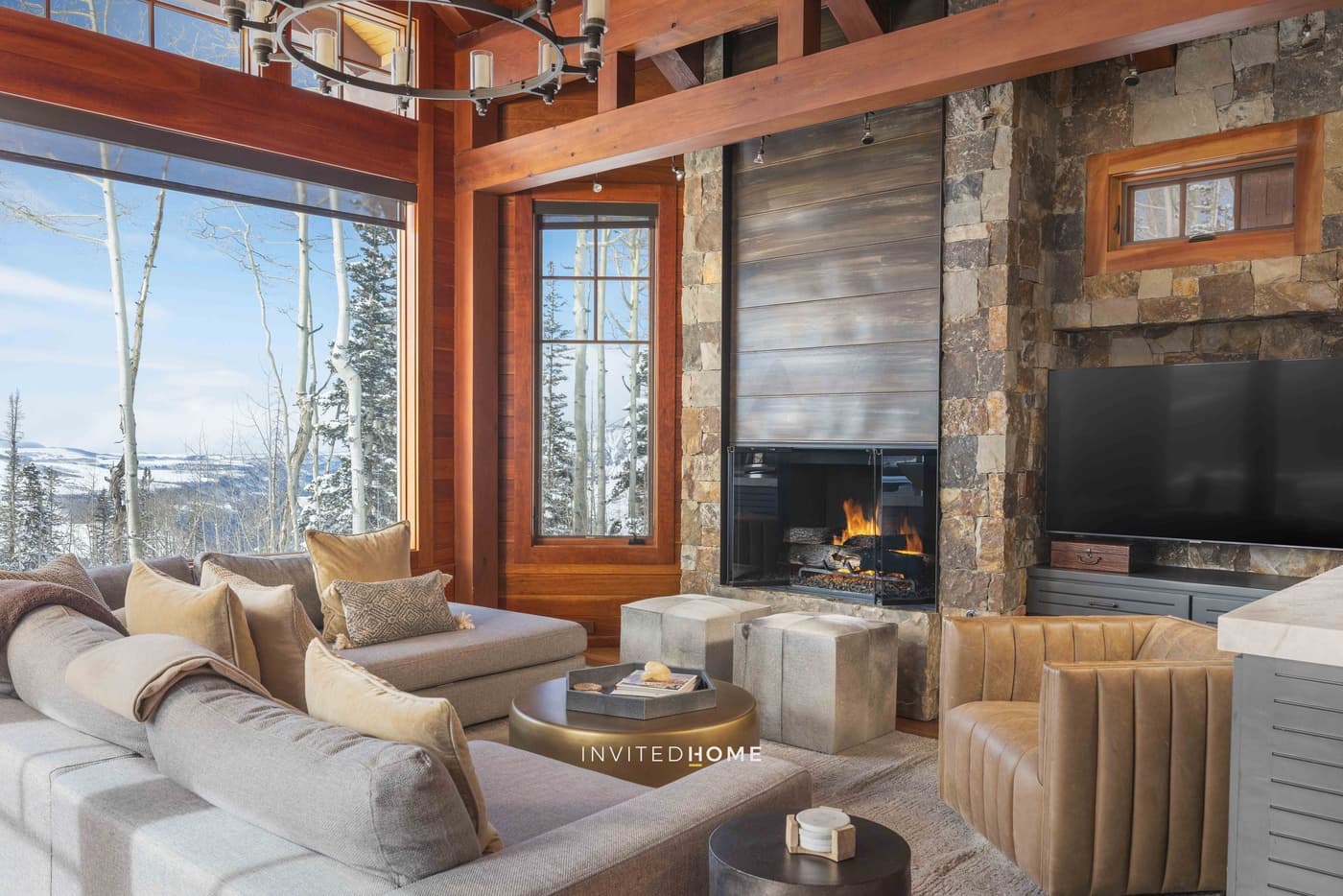 Luxury living room with fireplace, mountain views, and modern furnishings
