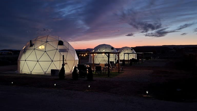 Multiple glowing domes at sunset with mountains in background